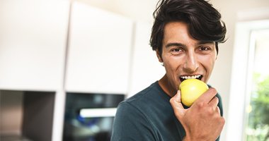 man enjoying an apple