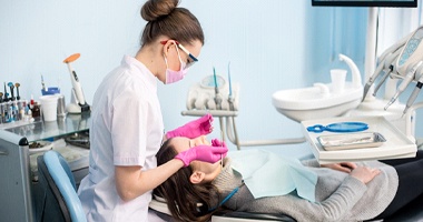 Dental hygienist performing scaling and root planing