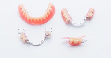 Full and partial dentures displayed against white background 