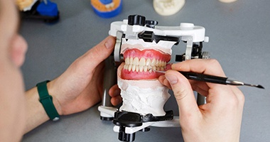 a dental lab technician making dentures