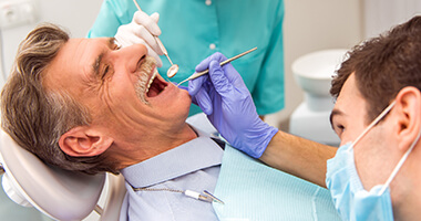 Senior man receiving dental treatment