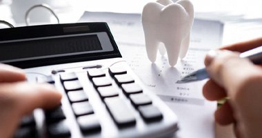 a person calculating the cost of their Invisalign treatment 