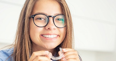 Smiling girl with Invisalign