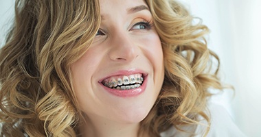 Smiling girl with traditional braces in Medford 